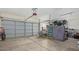 Spacious garage with a large roll up door, concrete floors, and storage area at 3720 E Vista Grande --, San Tan Valley, AZ 85140