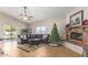 Spacious living room with a brick fireplace, tile flooring, and ample seating, perfect for relaxation at 3720 E Vista Grande --, San Tan Valley, AZ 85140