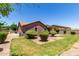 Backyard view with manicured lawn, landscaping, covered patio, and home's exterior at 40275 W Art Pl, Maricopa, AZ 85138