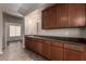 A bar area with dark wood cabinets, granite countertops, and a sink at 40275 W Art Pl, Maricopa, AZ 85138