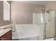 Bathroom features a soaking tub, separate shower stall, and a window providing natural light at 40275 W Art Pl, Maricopa, AZ 85138