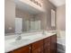 Bathroom boasts dual sinks, spacious vanity, and a separate bathtub with a glass-enclosed shower at 40275 W Art Pl, Maricopa, AZ 85138