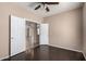 Bedroom features double doors leading to other rooms, complemented by wood-look flooring and neutral walls at 40275 W Art Pl, Maricopa, AZ 85138