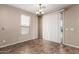 The dining room features neutral paint, tiled floors, a window, and a sliding glass door leading to the exterior at 40275 W Art Pl, Maricopa, AZ 85138