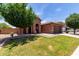 Charming single-story home with a well-maintained front yard, arched entry, and a two car garage at 40275 W Art Pl, Maricopa, AZ 85138
