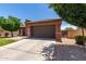 Charming single-story home with a well-maintained front yard, arched entry, and a two car garage at 40275 W Art Pl, Maricopa, AZ 85138