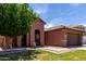 Charming single-story home with a well-maintained front yard, arched entry, and a two car garage at 40275 W Art Pl, Maricopa, AZ 85138