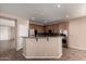 The kitchen features stainless steel appliances, granite countertops, and dark wood cabinets at 40275 W Art Pl, Maricopa, AZ 85138