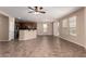 Spacious open living area with tile floors, eat-in kitchen and sliding glass door to back at 40275 W Art Pl, Maricopa, AZ 85138