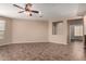 Spacious living room featuring tile floors, a ceiling fan and open floor plan at 40275 W Art Pl, Maricopa, AZ 85138