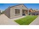 Charming covered patio with green lawn and stylish seating invites relaxation and outdoor enjoyment at 40441 W Hillman Dr, Maricopa, AZ 85138