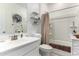 Clean bathroom with a white vanity, framed mirror, tub, and shower at 40441 W Hillman Dr, Maricopa, AZ 85138