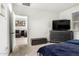 Bedroom with plush carpeting, dresser, and view to an adjacent sitting area at 40441 W Hillman Dr, Maricopa, AZ 85138