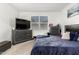 Bedroom with plush carpeting, dresser, and bright window overlooking the exterior at 40441 W Hillman Dr, Maricopa, AZ 85138