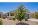 Well-maintained home with desert landscaping, a two-car garage, and a cozy front porch at 40441 W Hillman Dr, Maricopa, AZ 85138