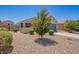 Well-maintained home with desert landscaping, a two-car garage, and a cozy front porch at 40441 W Hillman Dr, Maricopa, AZ 85138