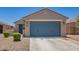 Inviting single-story home featuring a two-car garage, desert landscaping, and a covered front entry at 40441 W Hillman Dr, Maricopa, AZ 85138