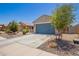 Attractive home featuring a two-car garage, low-maintenance landscaping, and a private front courtyard at 40441 W Hillman Dr, Maricopa, AZ 85138