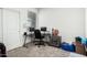 Office space featuring a sleek black desk, two monitors, and natural lighting at 40441 W Hillman Dr, Maricopa, AZ 85138