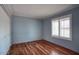Cozy bedroom with hardwood floors, window shutters, and a closet with paneled doors at 4079 E Shangri La Rd, Phoenix, AZ 85028