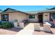 Inviting front porch with a cozy seating area and charming brick accents and an american flag at 4079 E Shangri La Rd, Phoenix, AZ 85028