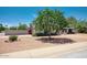 Charming single-story home with desert landscaping, mature shade tree, and block fence at 4079 E Shangri La Rd, Phoenix, AZ 85028