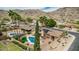 Beautiful backyard pool with palm trees and an artificial grass area, set in a desert landscape with mountain views at 4229 E Pearce Rd, Phoenix, AZ 85044
