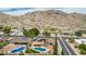 Expansive aerial view of a desert neighborhood showcasing a home with a pool and mountain backdrop at 4229 E Pearce Rd, Phoenix, AZ 85044