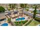 Desert home featuring a fenced pool, covered patio, desert landscaping, and palm trees, set in a quiet neighborhood at 4229 E Pearce Rd, Phoenix, AZ 85044