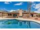 Back yard with a pool, a mountain view, rocks and a green turtle in the pool at 4229 E Pearce Rd, Phoenix, AZ 85044