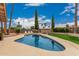 Inviting backyard featuring a sparkling pool, lush lawn, and well-maintained desert landscaping for outdoor enjoyment at 4229 E Pearce Rd, Phoenix, AZ 85044