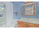 Bright bathroom features a shower with white curtain, mirror, toilet, and vanity with marble countertop at 4229 E Pearce Rd, Phoenix, AZ 85044