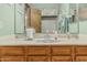 Bathroom with wood cabinets, a large mirror and a sink that sits in the middle at 4229 E Pearce Rd, Phoenix, AZ 85044