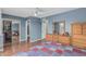 A spacious bedroom boasts blue walls, a closet, and warm, neutral tones with ample storage at 4229 E Pearce Rd, Phoenix, AZ 85044