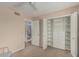 Bedroom with a ceiling fan, an open doorway and a closet with built in shelving at 4229 E Pearce Rd, Phoenix, AZ 85044