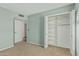 Bedroom with light blue walls and a closet with built in shelves for storage at 4229 E Pearce Rd, Phoenix, AZ 85044