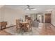 Living and dining area featuring a wooden table with seating for four, office space, and tile flooring at 4229 E Pearce Rd, Phoenix, AZ 85044