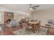 Living space with a fireplace, tile flooring, ceiling fan, and dining area with seating for four at 4229 E Pearce Rd, Phoenix, AZ 85044