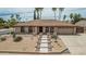 Charming desert home featuring a well-manicured front yard, arched windows, and a two-car garage at 4229 E Pearce Rd, Phoenix, AZ 85044