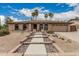 Charming home with neutral stucco, landscaped with palm trees, and a walkway leading to the front door at 4229 E Pearce Rd, Phoenix, AZ 85044