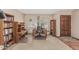 Home office featuring wooden desk and bookshelves, arched windows with views of the front yard at 4229 E Pearce Rd, Phoenix, AZ 85044