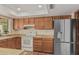 A well-lit kitchen has wooden cabinets and modern appliances, providing a functional and stylish cooking space at 4229 E Pearce Rd, Phoenix, AZ 85044