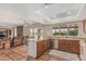Kitchen with terracotta floors and a breakfast bar flows seamlessly into a living area with a brick fireplace and comfortable seating at 4229 E Pearce Rd, Phoenix, AZ 85044