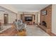 Spacious living room featuring a fireplace, neutral walls, tile flooring, and two lounge chairs at 4229 E Pearce Rd, Phoenix, AZ 85044