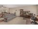Living room featuring a patterned sofa, wooden desk, and access to a dining area at 4229 E Pearce Rd, Phoenix, AZ 85044