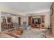 Open living space with a fireplace, neutral walls, tile flooring, and access to a dining area at 4229 E Pearce Rd, Phoenix, AZ 85044