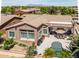An aerial shot showcases a home with a pool, outdoor grill, and manicured landscaping at 42293 W Good Vibrations Ln, Maricopa, AZ 85138