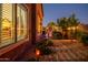 Landscaped backyard with stone walkway, desert plants, and stylish outdoor lighting at dusk at 42293 W Good Vibrations Ln, Maricopa, AZ 85138
