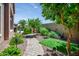 Backyard garden with a brick pathway and lush landscaping, offering a tranquil outdoor space at 42293 W Good Vibrations Ln, Maricopa, AZ 85138