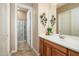 Bathroom vanity with a floral decoration, mirror and shower at 42293 W Good Vibrations Ln, Maricopa, AZ 85138